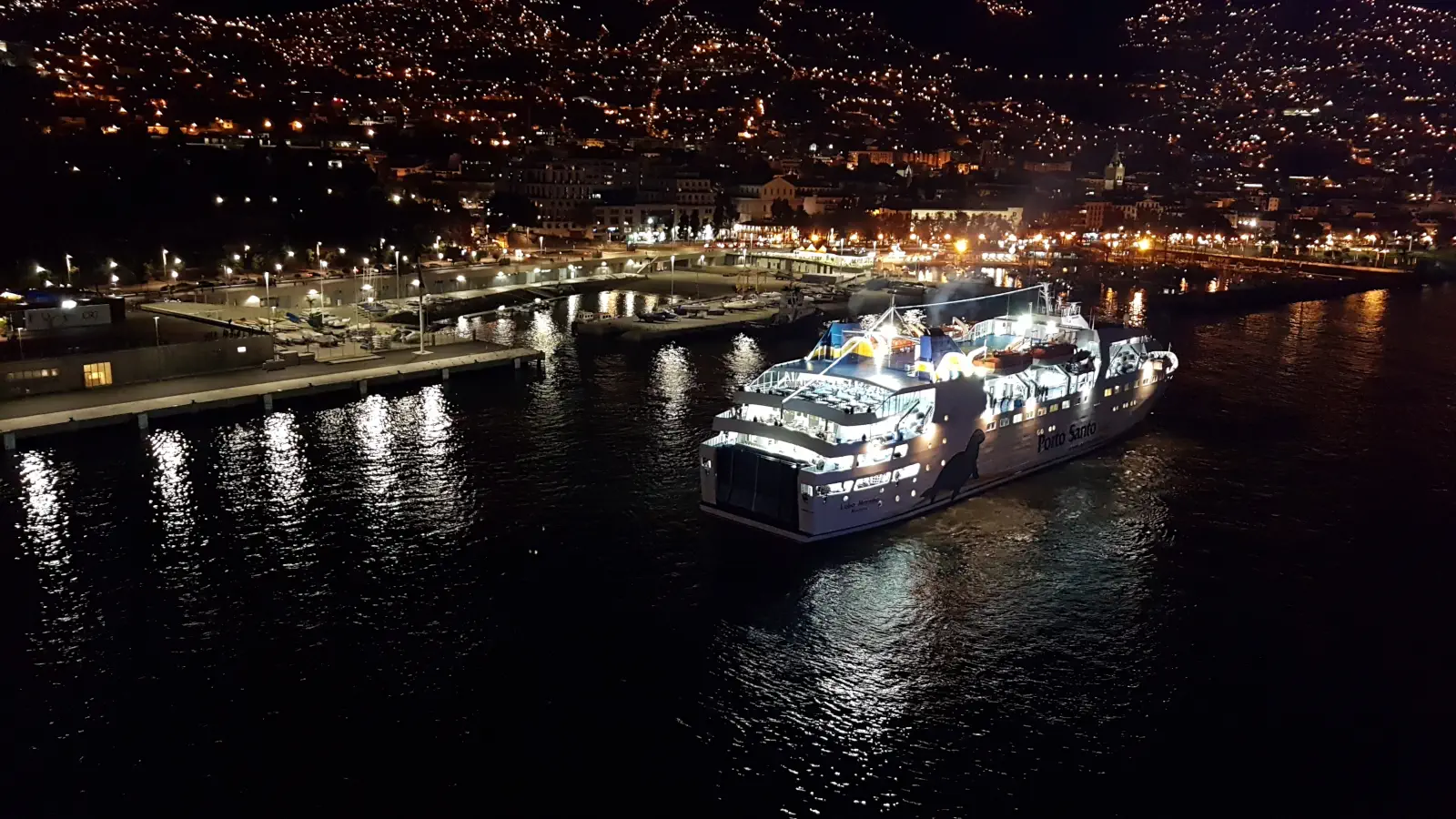 Statek Porto Santo Line Prom Lobo Marinho wpływa wieczorem do portu w Funchal na Maderze.